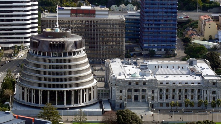 Aerial view of the Beehive and New Zealand Parliament building, with surrounding buildings.