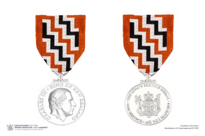 Composite of obverse and reverse of the King's Service Medal on ribbon